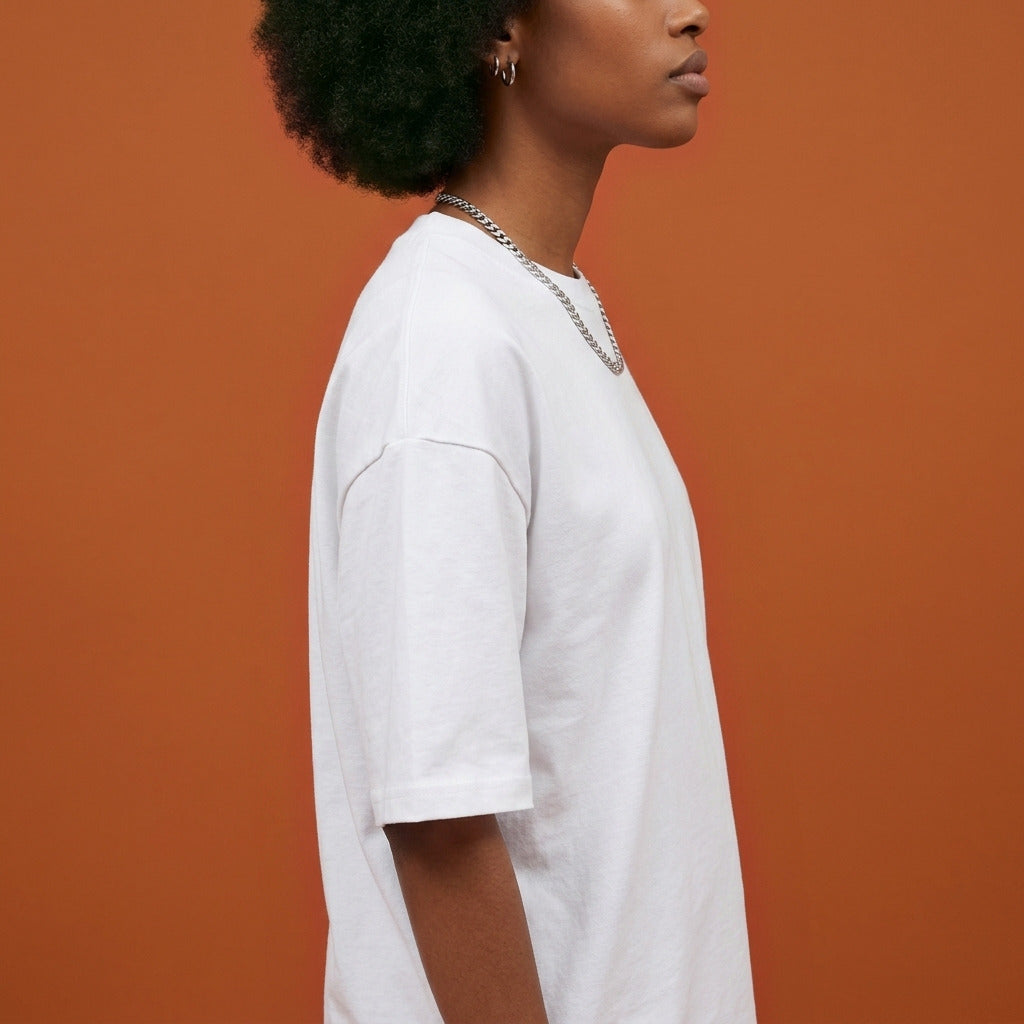 Blackness Sankofa Queen Tee, white — shoulder and collar detail, side view, terracotta backdrop