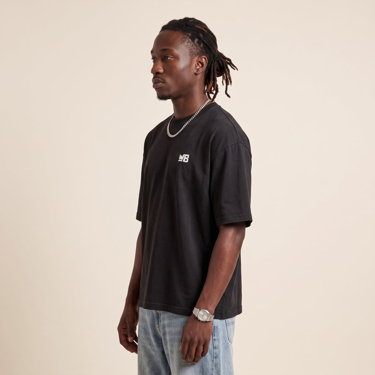 Base Blackness Tee Black — side view of the drop-shoulder sleeve and boxy oversized fit, oversized heavyweight cotton streetwear tee by We Are Blackness