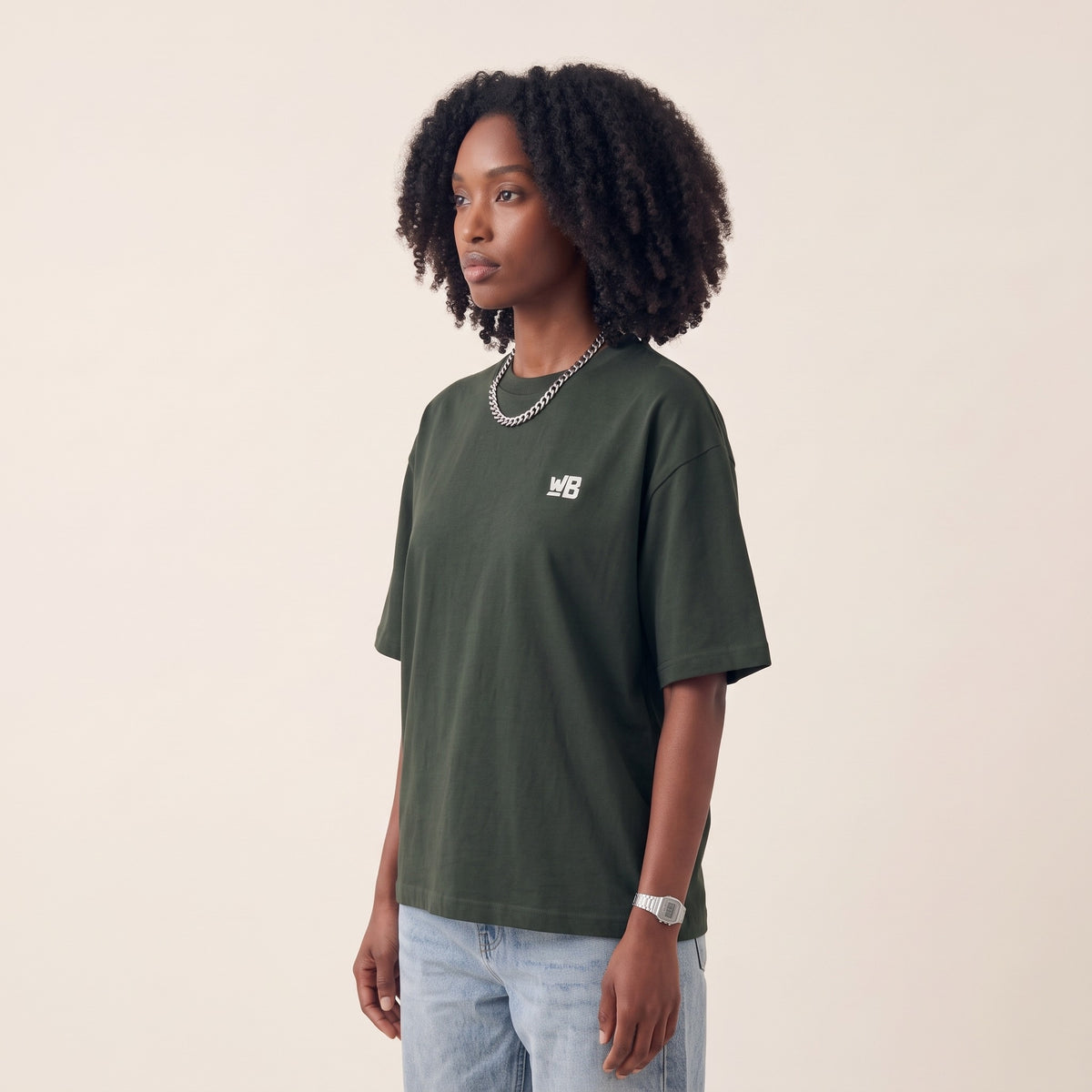 Base Blackness Tee Green — side view of the drop-shoulder sleeve and boxy oversized fit, oversized heavyweight cotton streetwear tee by We Are Blackness