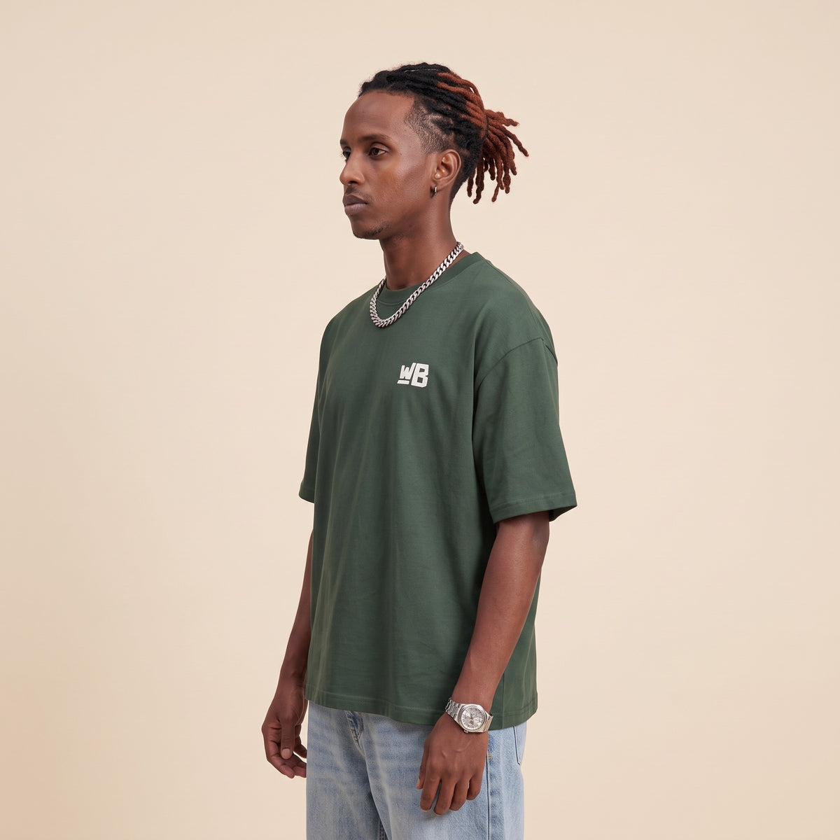 Blackness Emancipation Tee Cactus Green — side view of the drop-shoulder sleeve and boxy oversized fit, oversized heavyweight cotton streetwear tee by We Are Blackness
