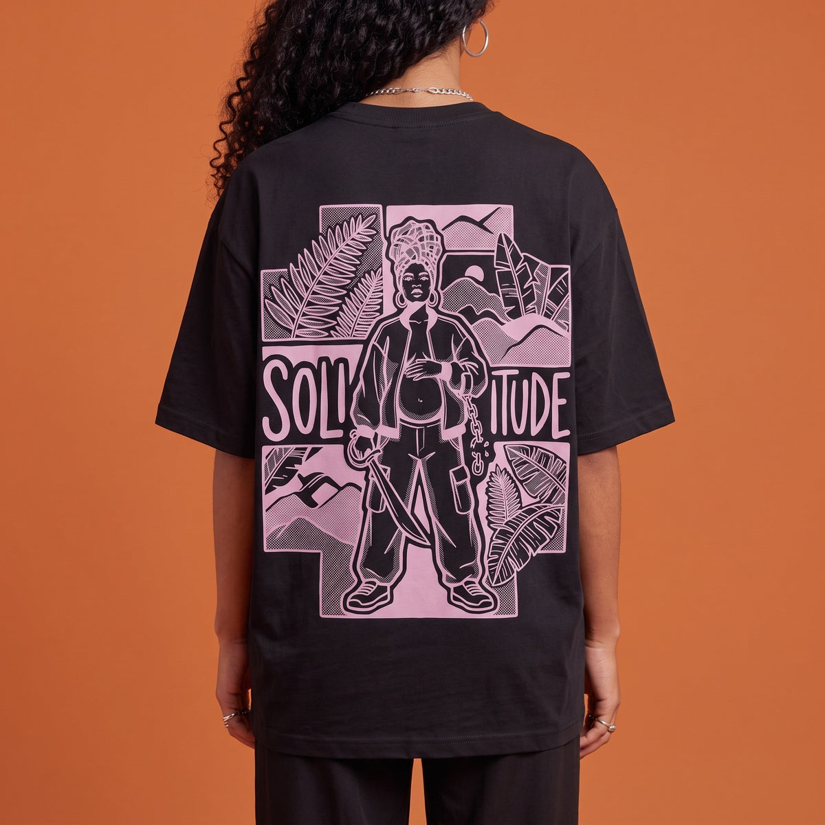 Blackness Solitude Tee Black — close-up of the Solitude block-print portrait back graphic worn on the back, oversized heavyweight cotton streetwear tee by We Are Blackness