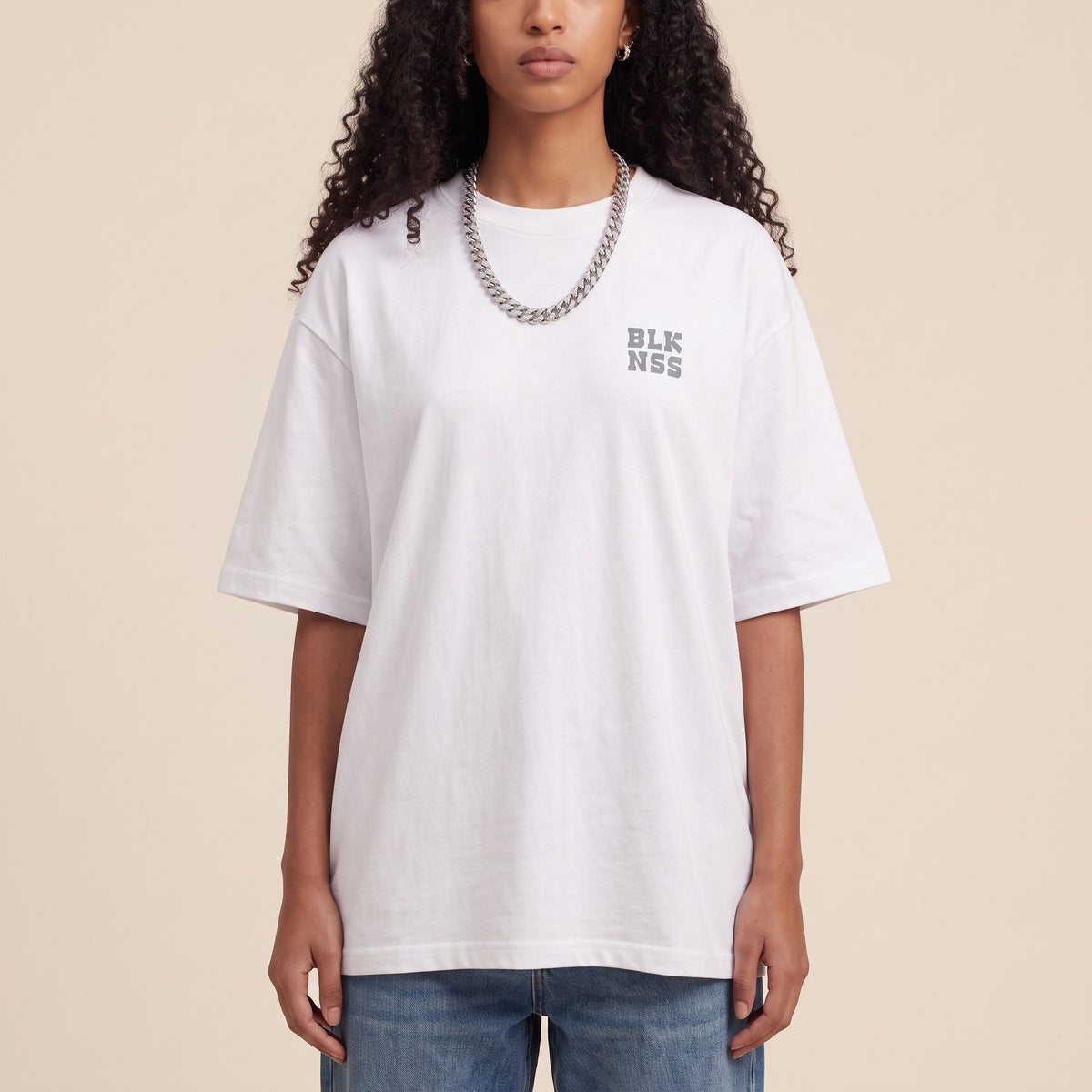 Blackness WABLKNSS Tee White — close-up of the BLK NSS chest logo and ribbed collar, oversized heavyweight cotton streetwear tee by We Are Blackness