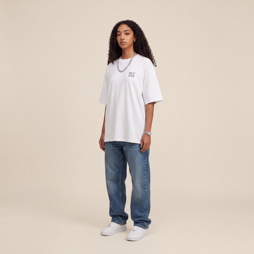 Blackness WABLKNSS Tee White worn by model, front view on beige studio backdrop