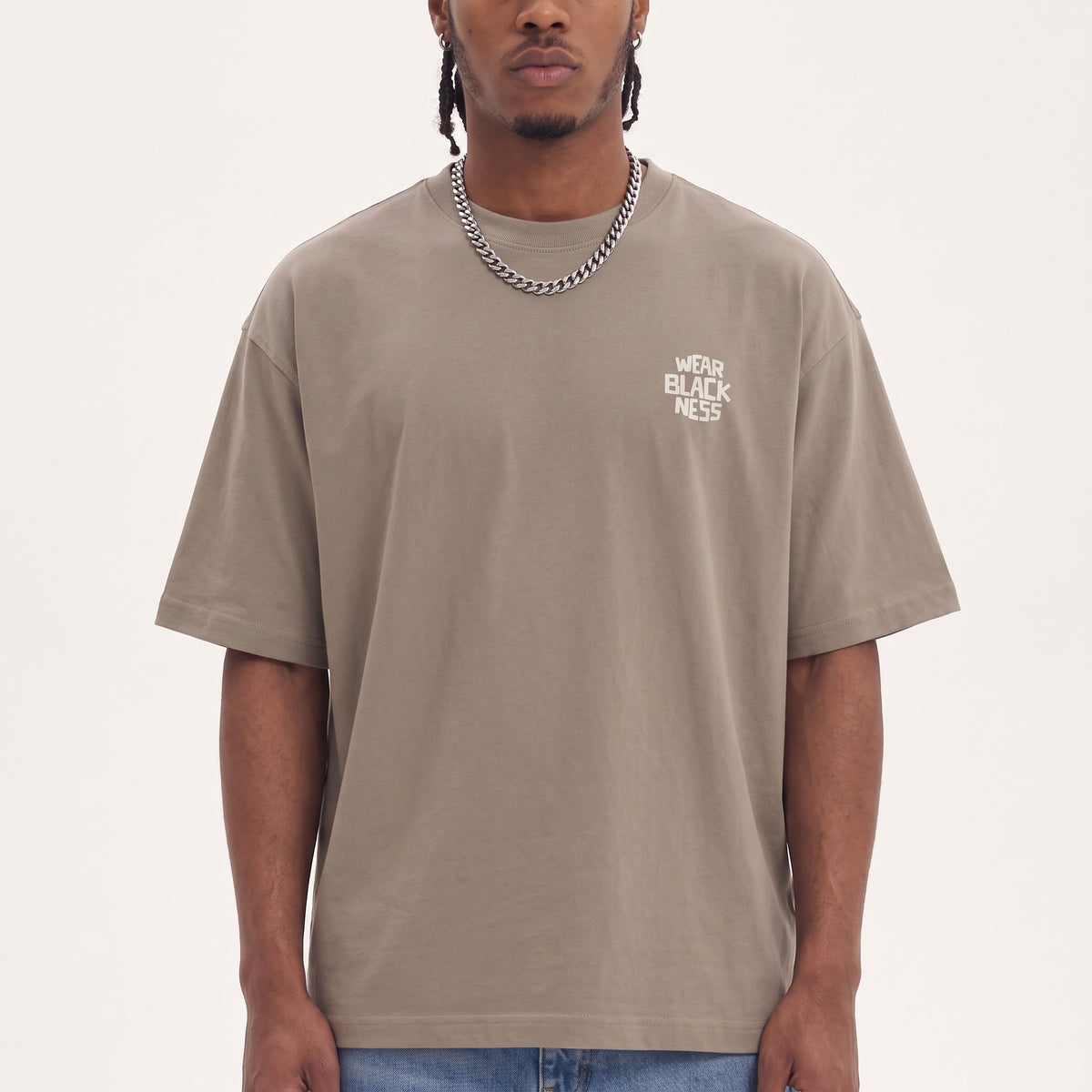 Wear Blackness Tee Brown — close-up of the Wear Blackness chest logo and ribbed collar, oversized heavyweight cotton streetwear tee by We Are Blackness